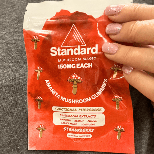 holding amanita muscaria mushroom gummies